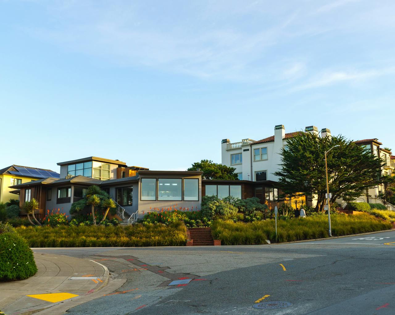 A row of modern houses on a sunny corner showcasing contemporary architecture.
